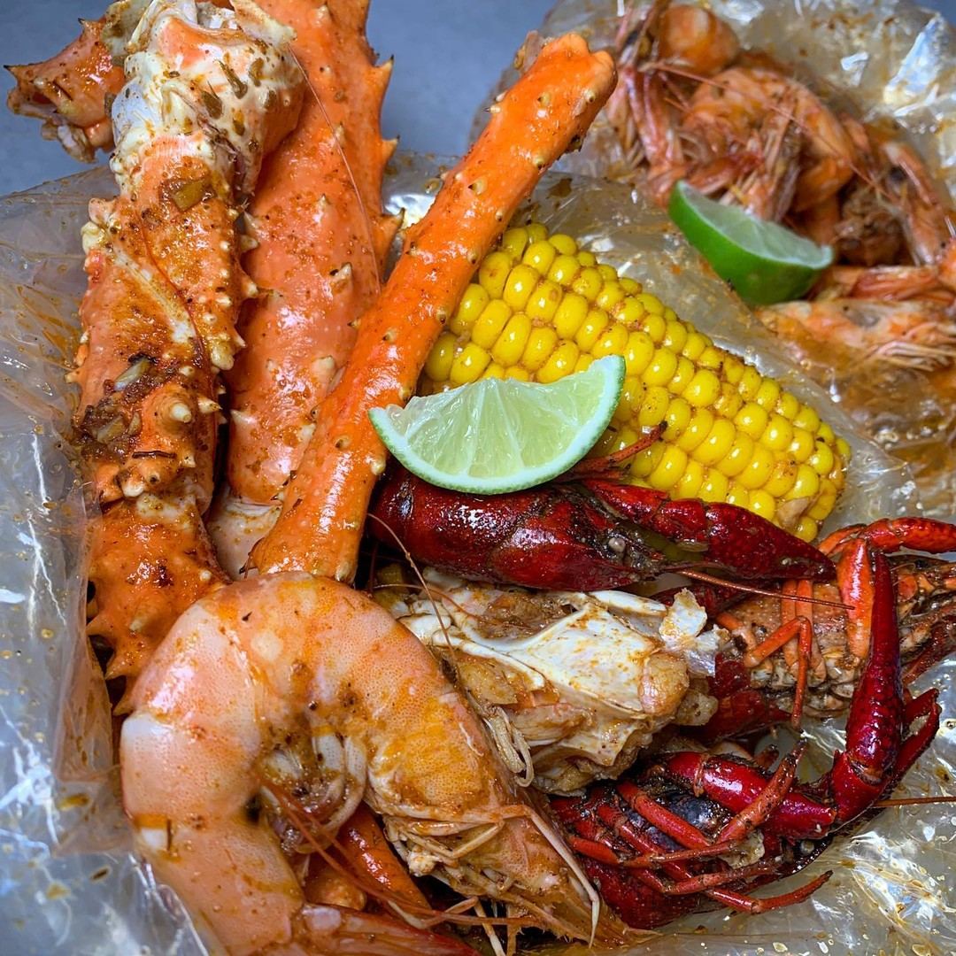 Crab legs, lobster and shrimp boil with corn